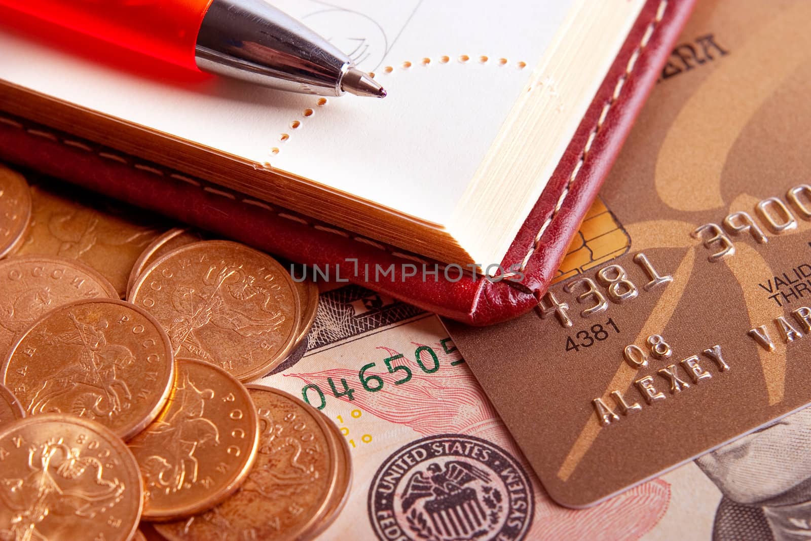 Business still-life: a pen, a diary and money