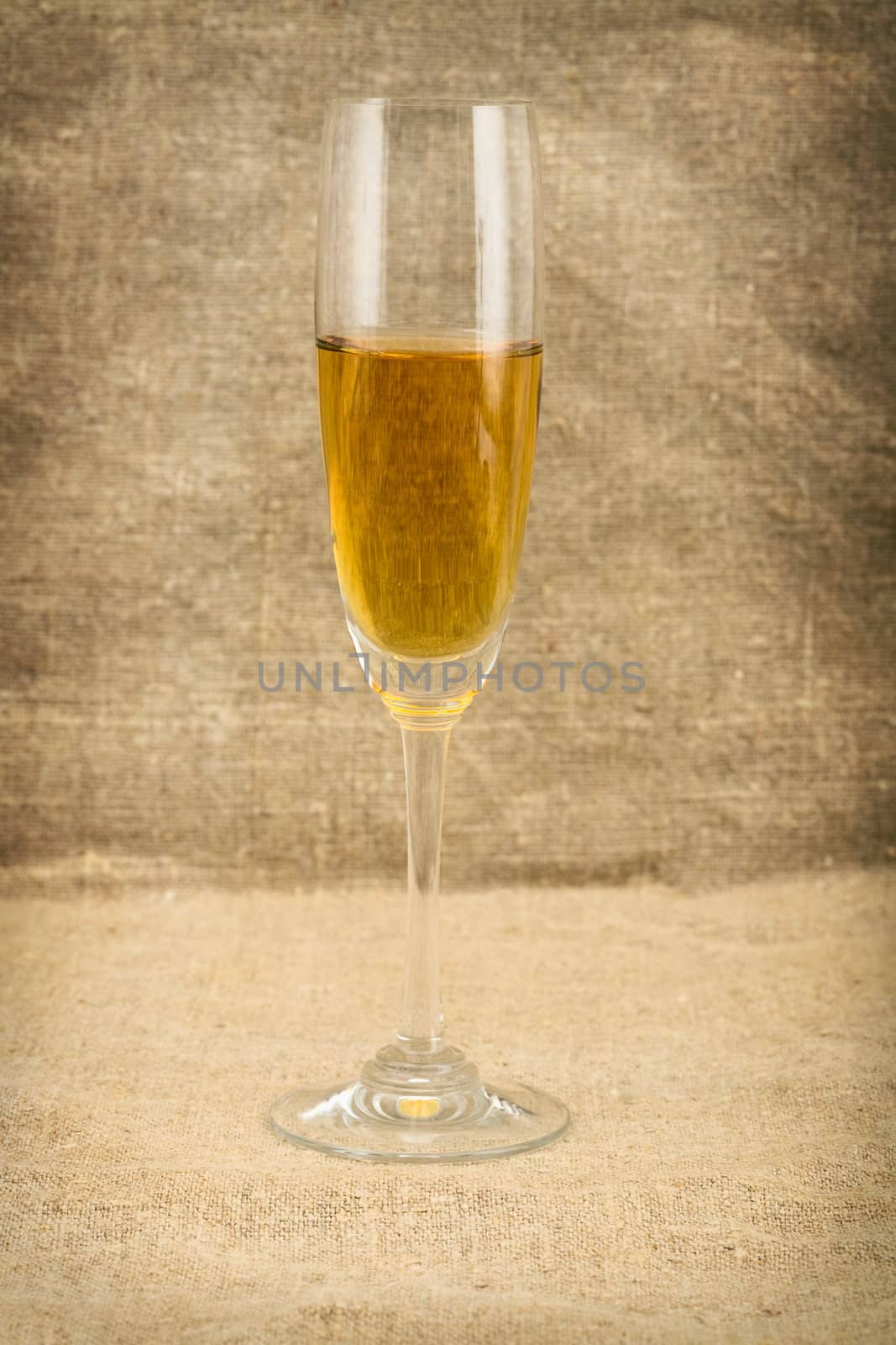 Bucket of wine on sacking background