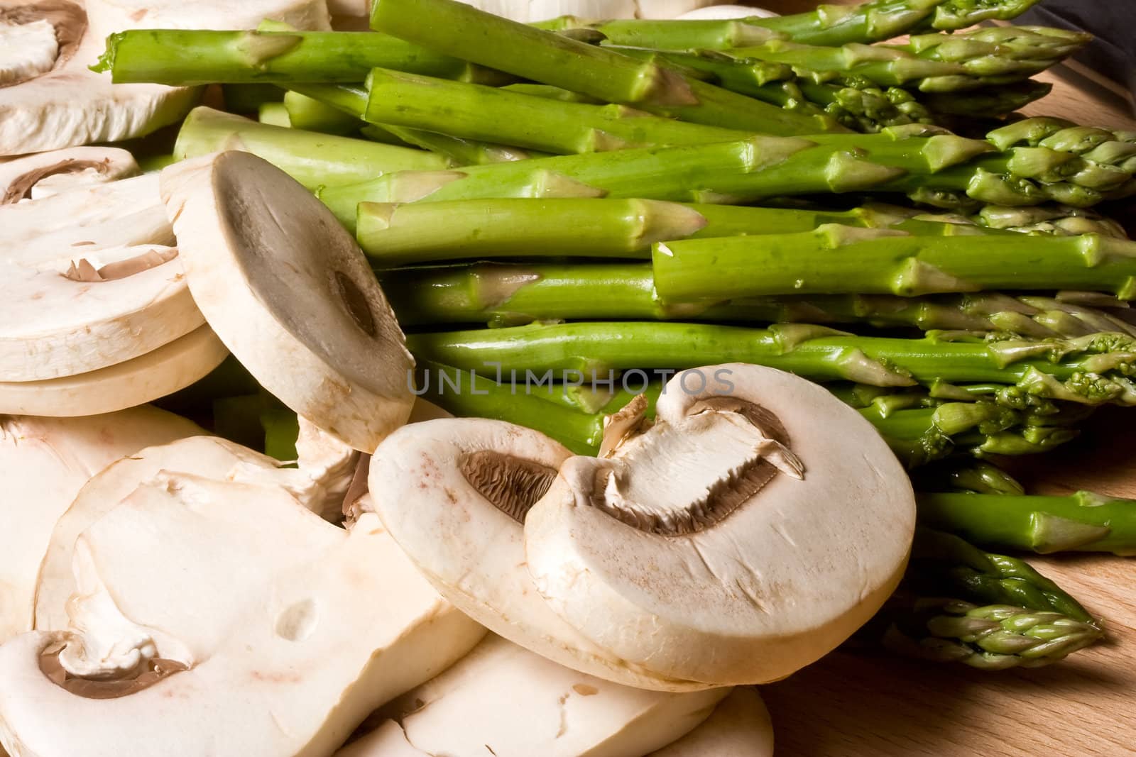 fresh mushrooms and asparagus on a cutting board healthy