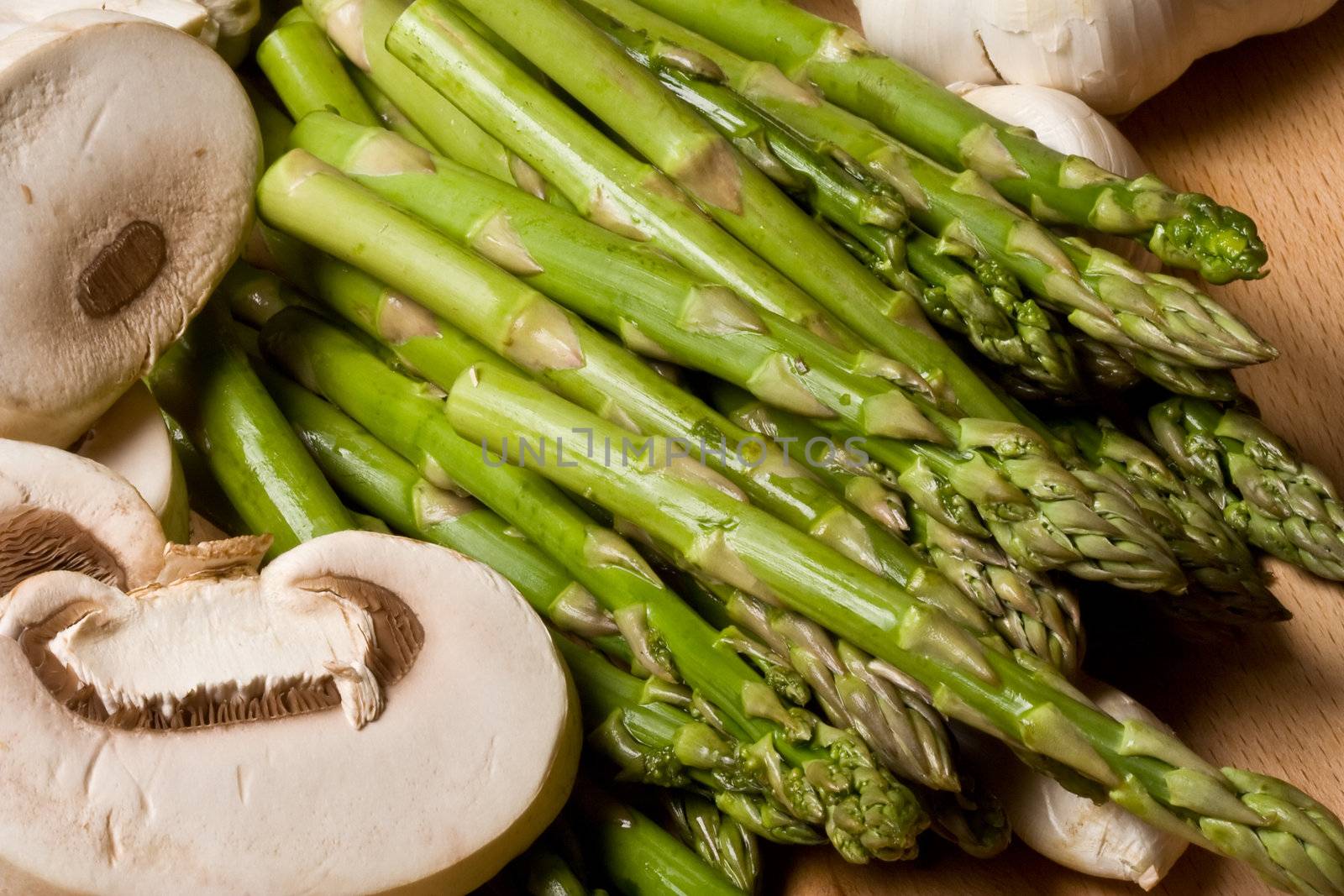 fresh mushrooms and aspargus on a cutting board healthy