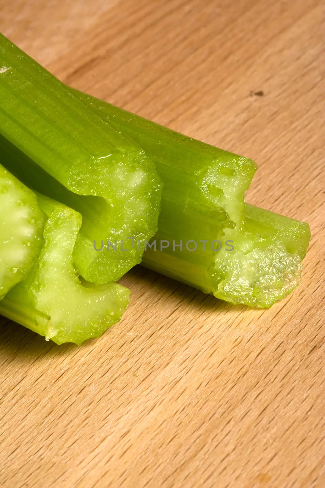 fresh green celery on a wood cutting board