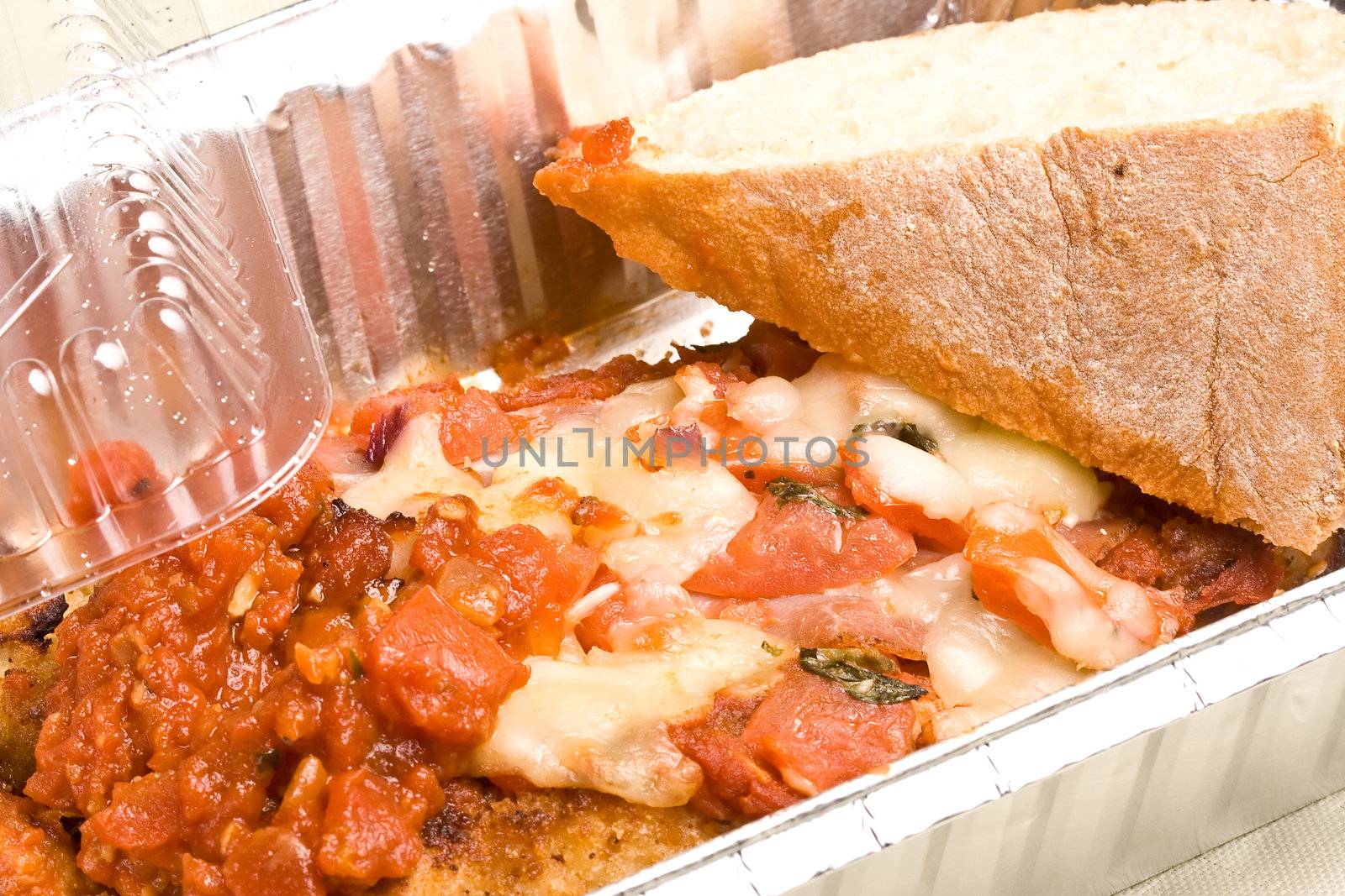 carry out meal chicken parmesan with a slice of bread in the carry out container