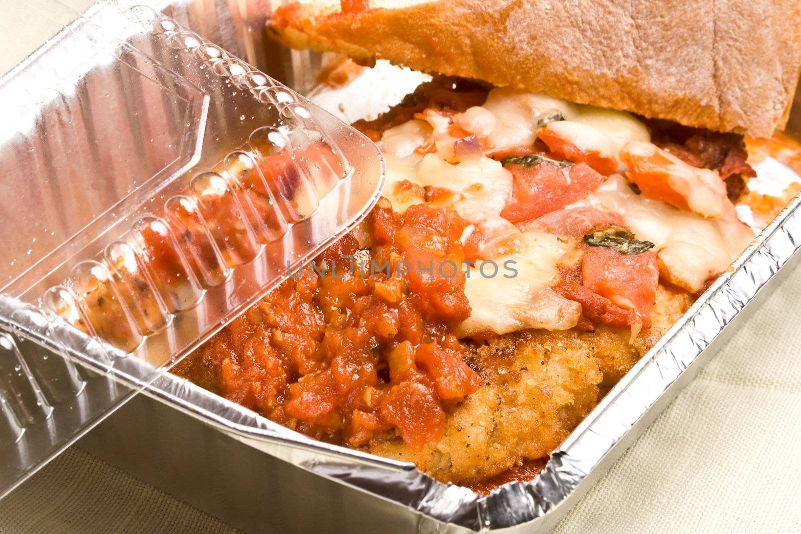 carry out meal chicken parmesan with a slice of bread in the carry out container