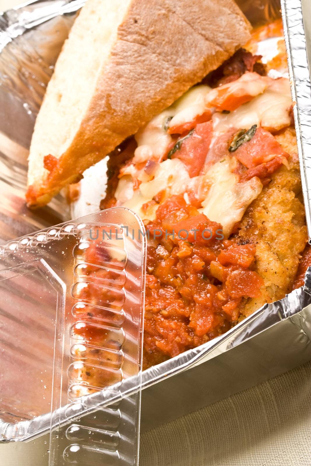 carry out meal chicken parmesan with a slice of bread in the carry out container