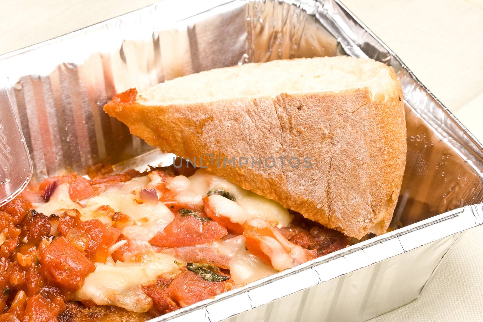 carry out meal chicken parmesan with a slice of bread in the carry out container