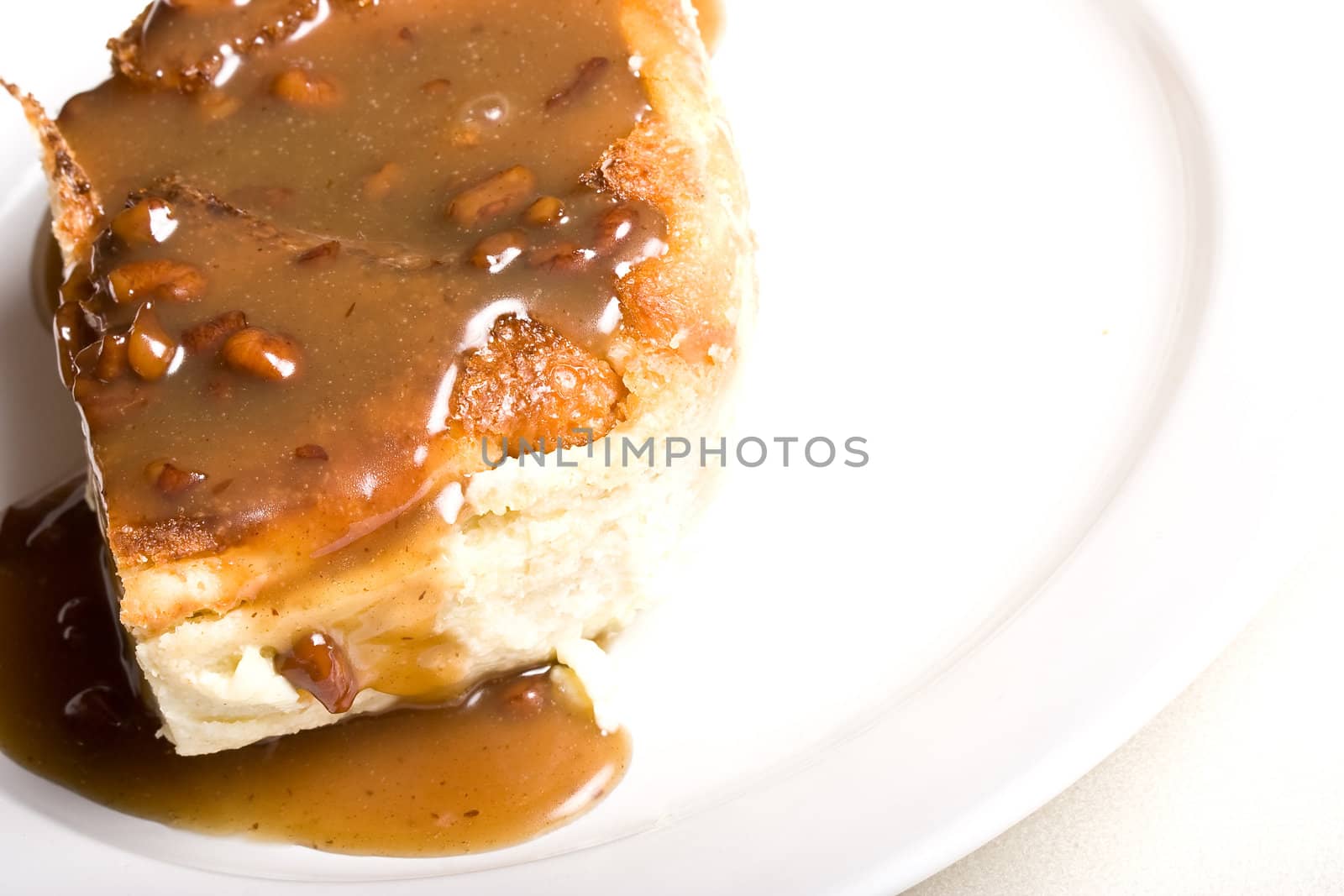 fresh hot bread pudding topped with caramel syrup and pecans