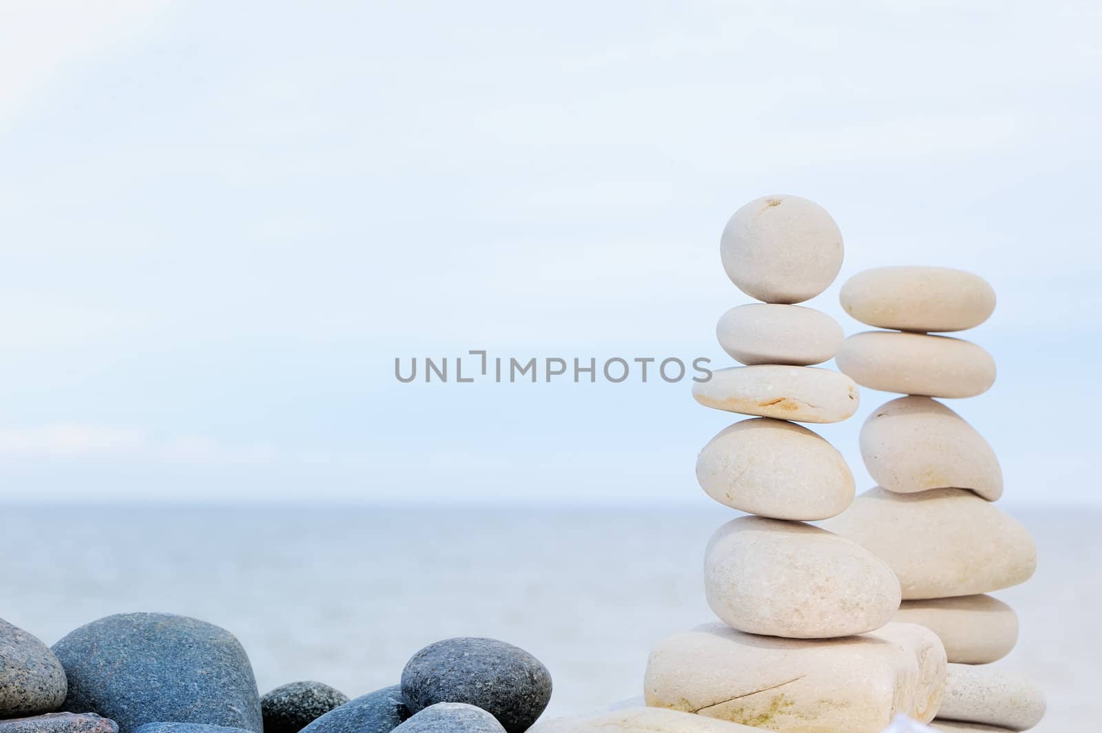 Two pile of pebbles in the balance on the seacoast