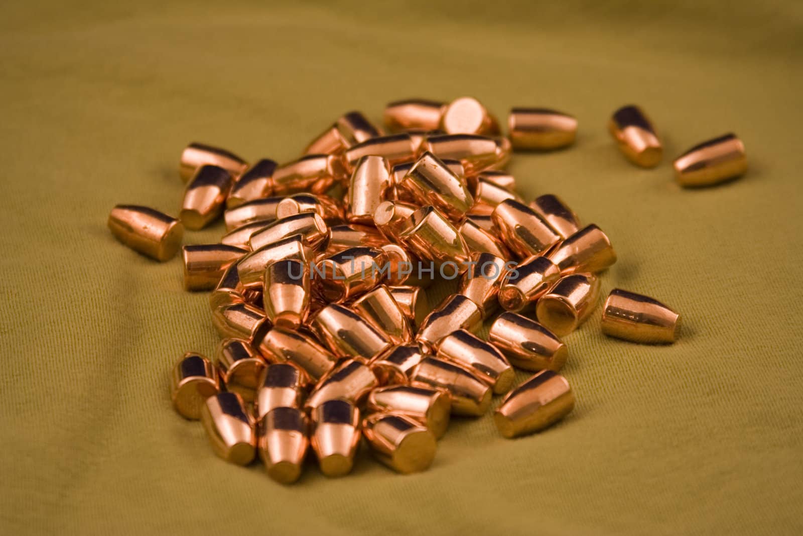 9 mm flat point bullets on a green background