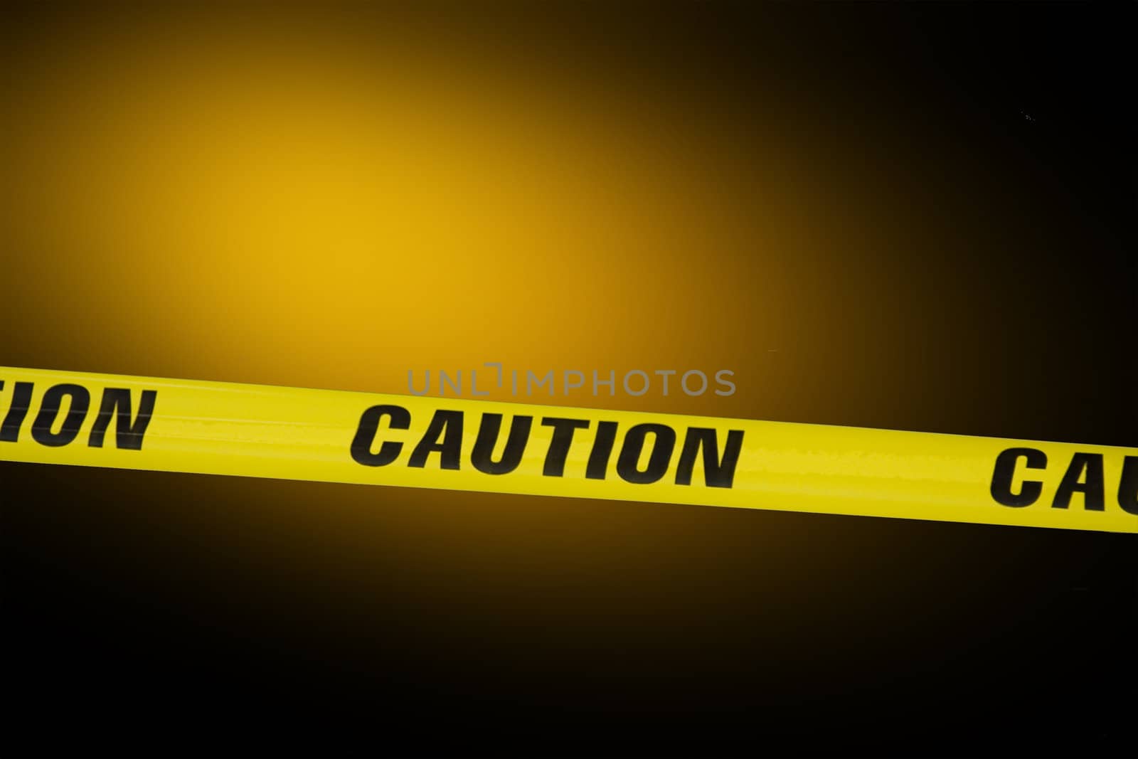 Caution tape over a black background with flashing lights in the background