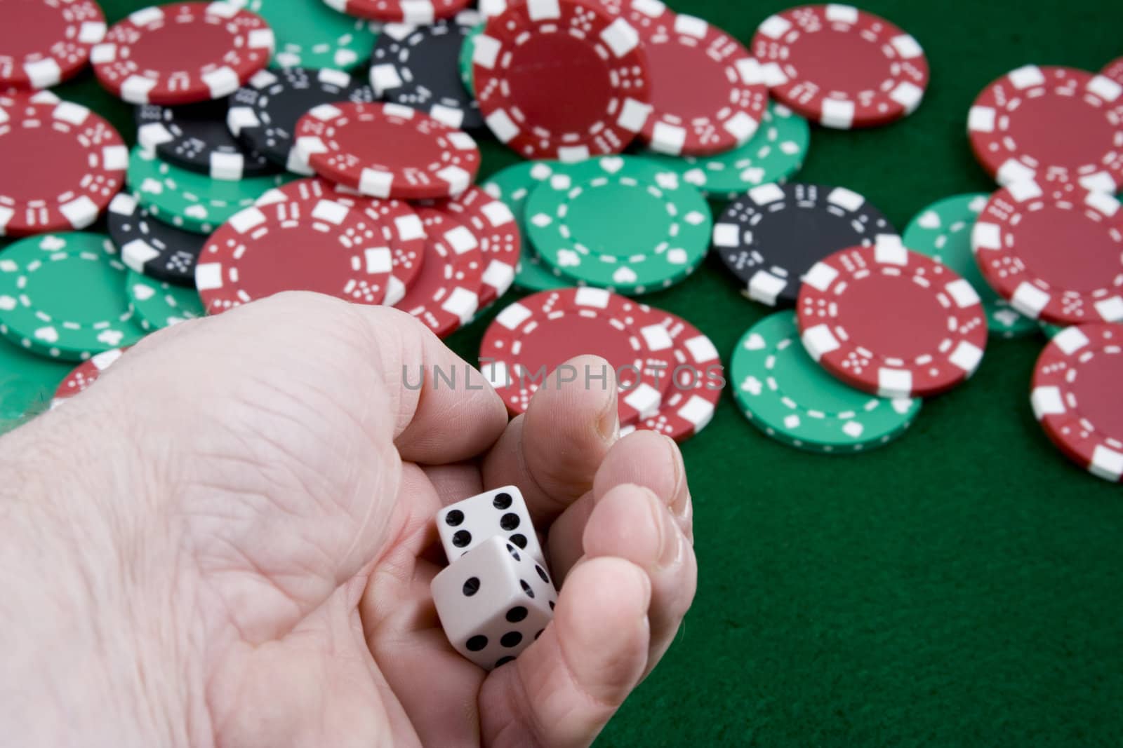 close up of a hand getting ready to roll a pair of die