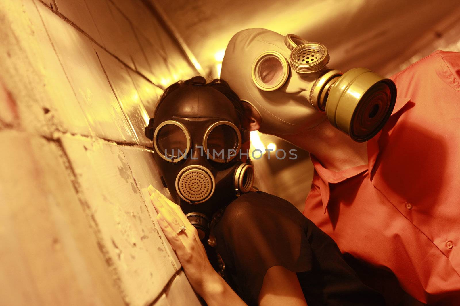 Married couple in gas masks in a tunnel