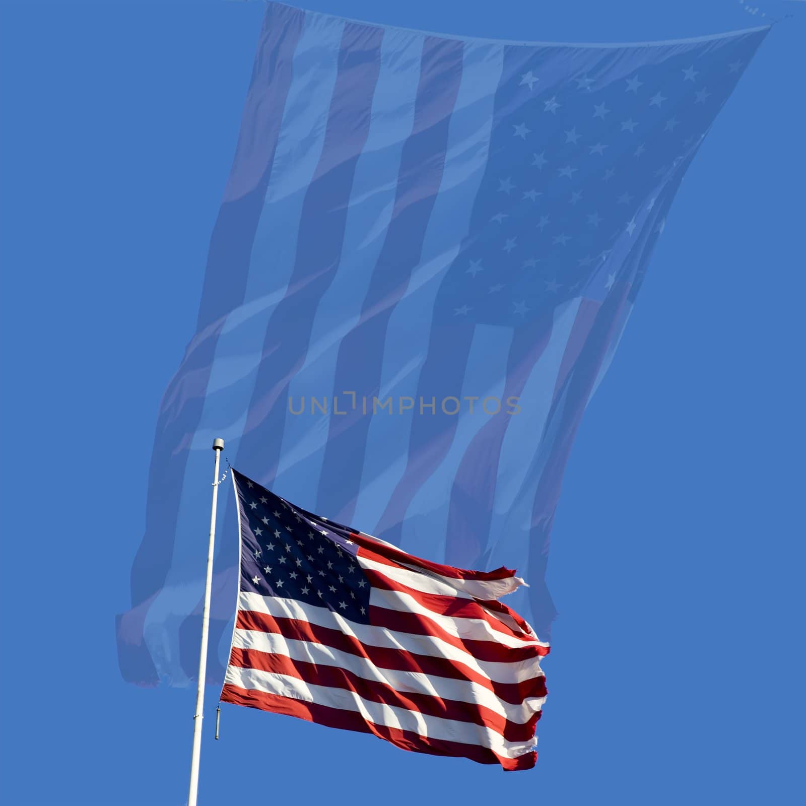 Stars and stripes flying in the wind on deep blue sky nice background for a patriotic display

