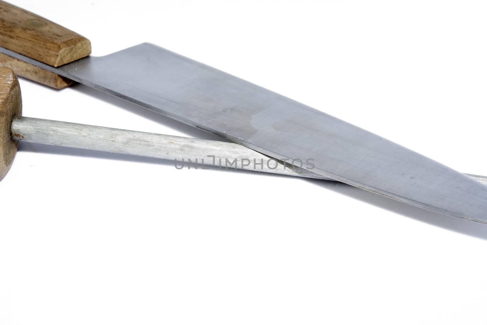knife getting sharpened by a stell on white background