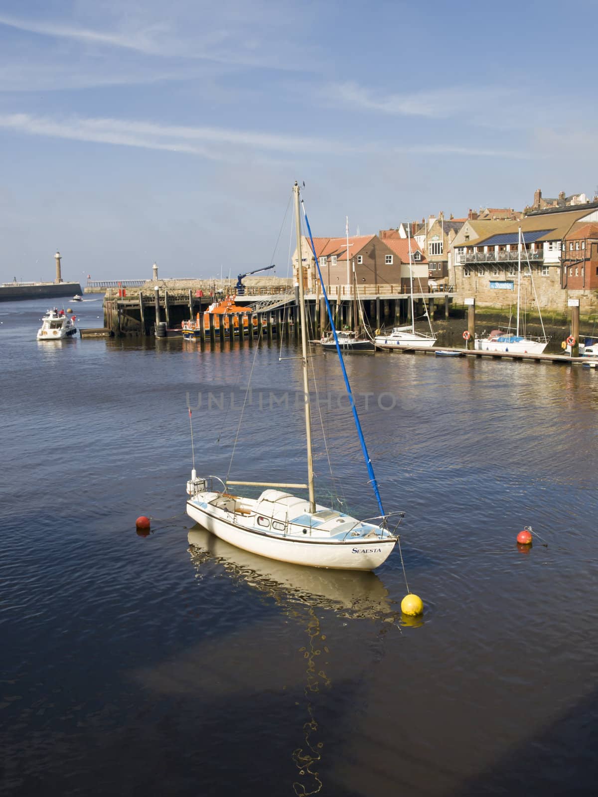A tranquil scene at Whitby with a boat at rest in the harbour
