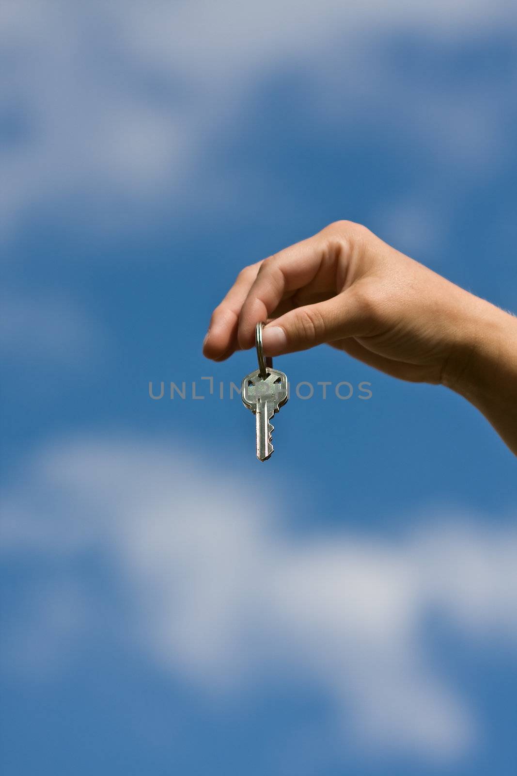 woman handing another woman keys to a house