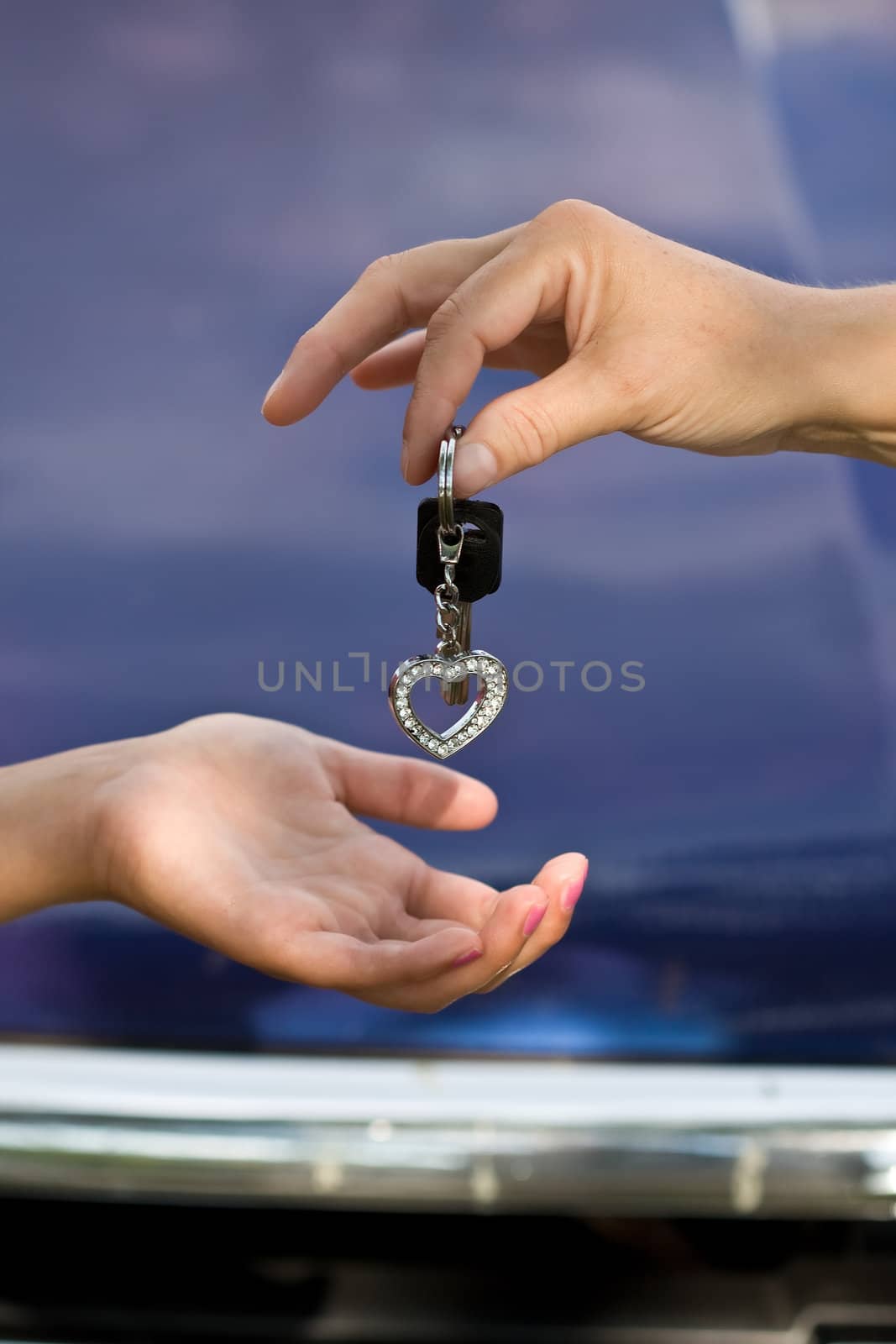 hands and car keys woman heart on key chain