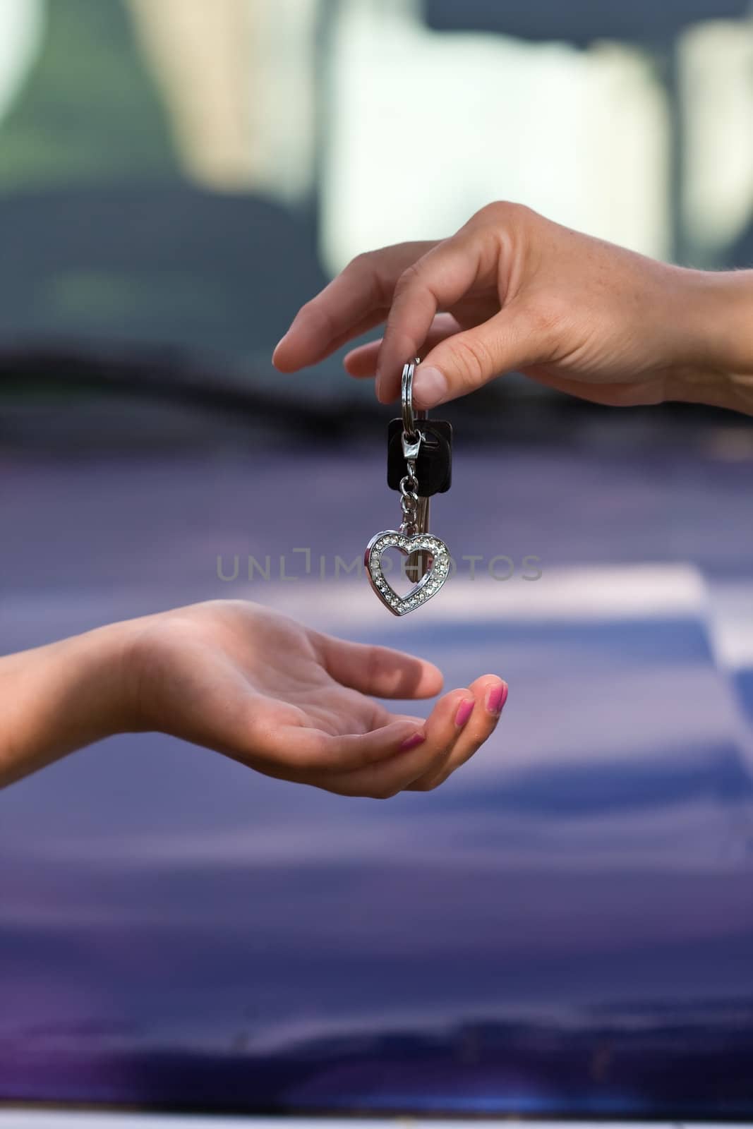 hands and car keys woman heart on key chain