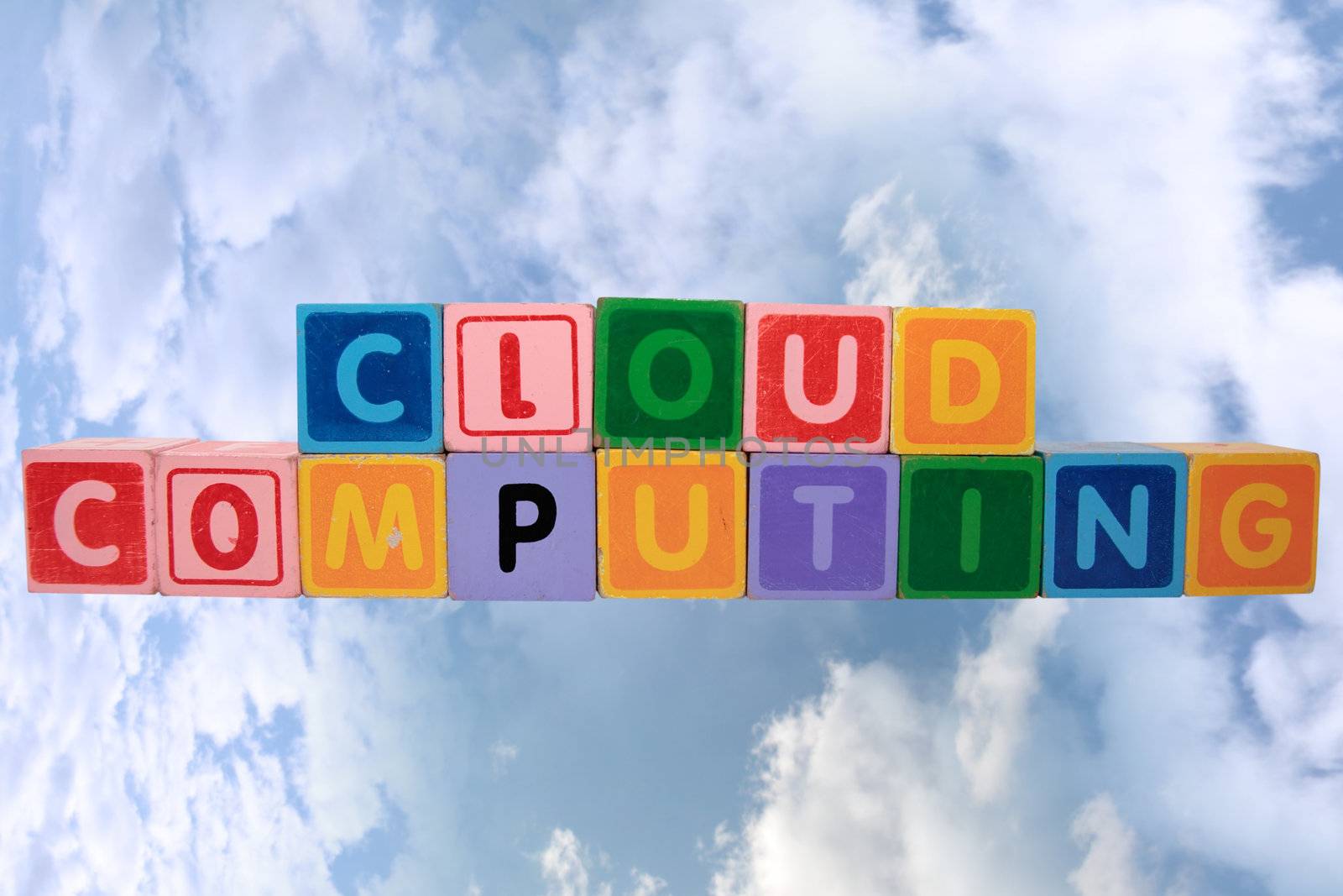 toy letters that spell cloud computing against a cloudy background with clipping path