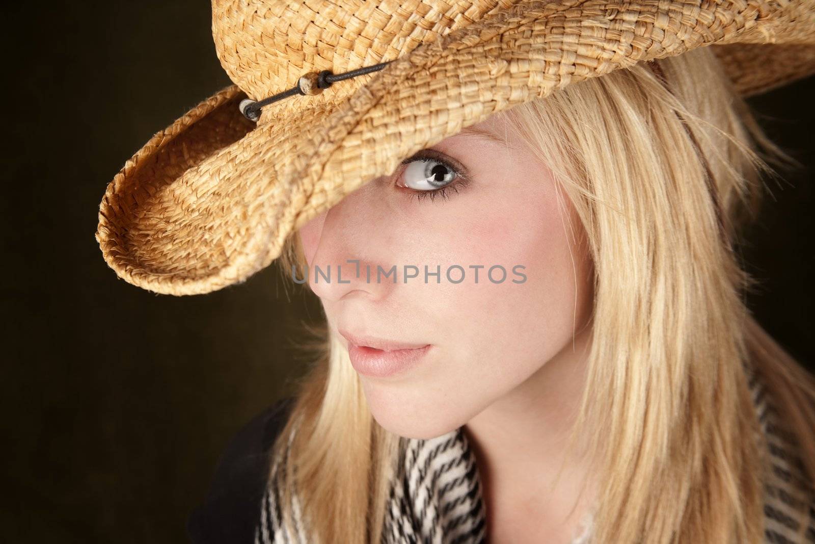 Blonde teenager wearing a straw cowboy hat
