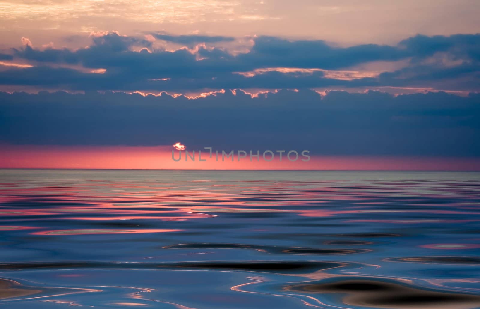 colorful sunset over smooth waves striking colors