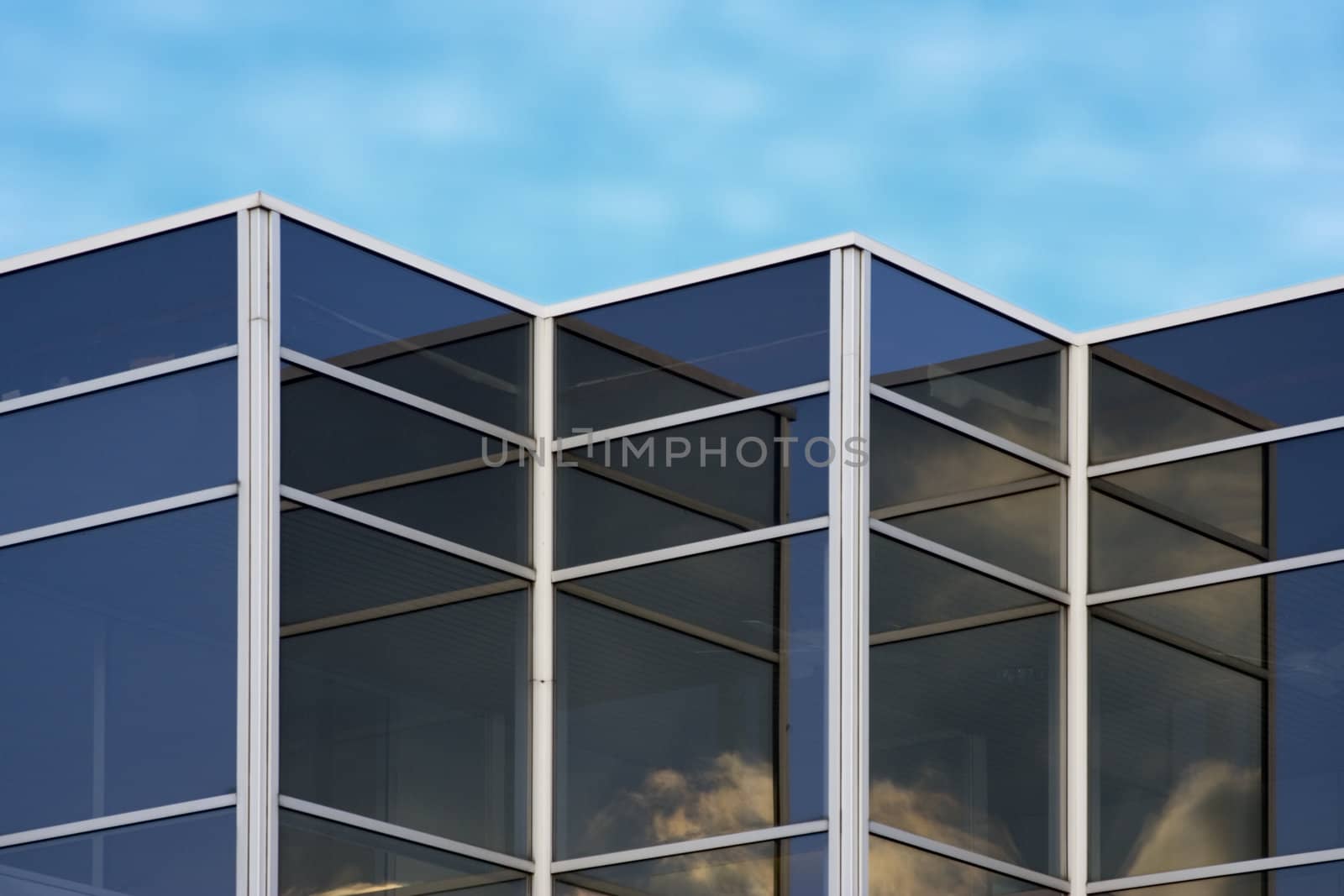 cloud reflections in office building window glass