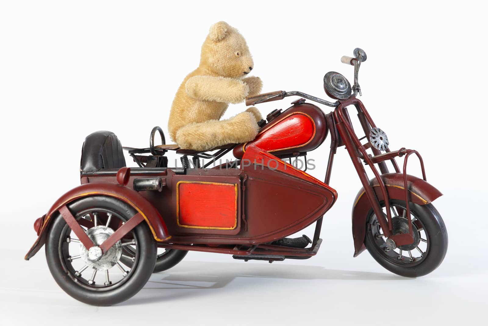 Teddy riding a motorbike toy