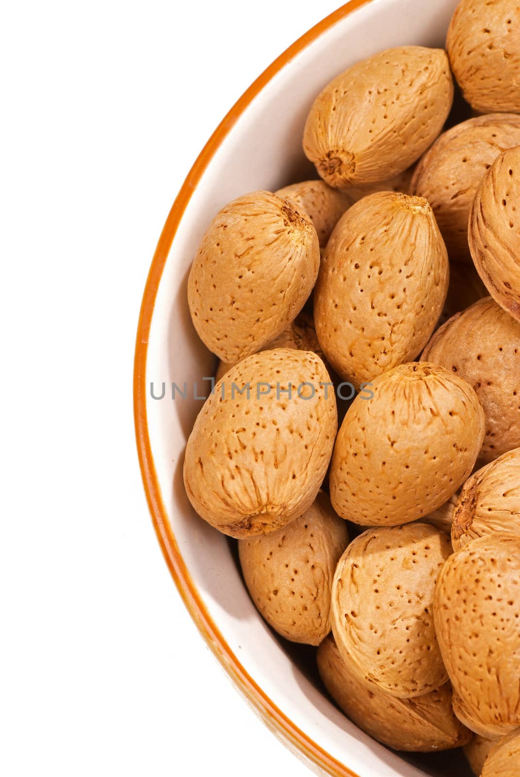 Unshelled fresh almonds in a bowl, copy space available