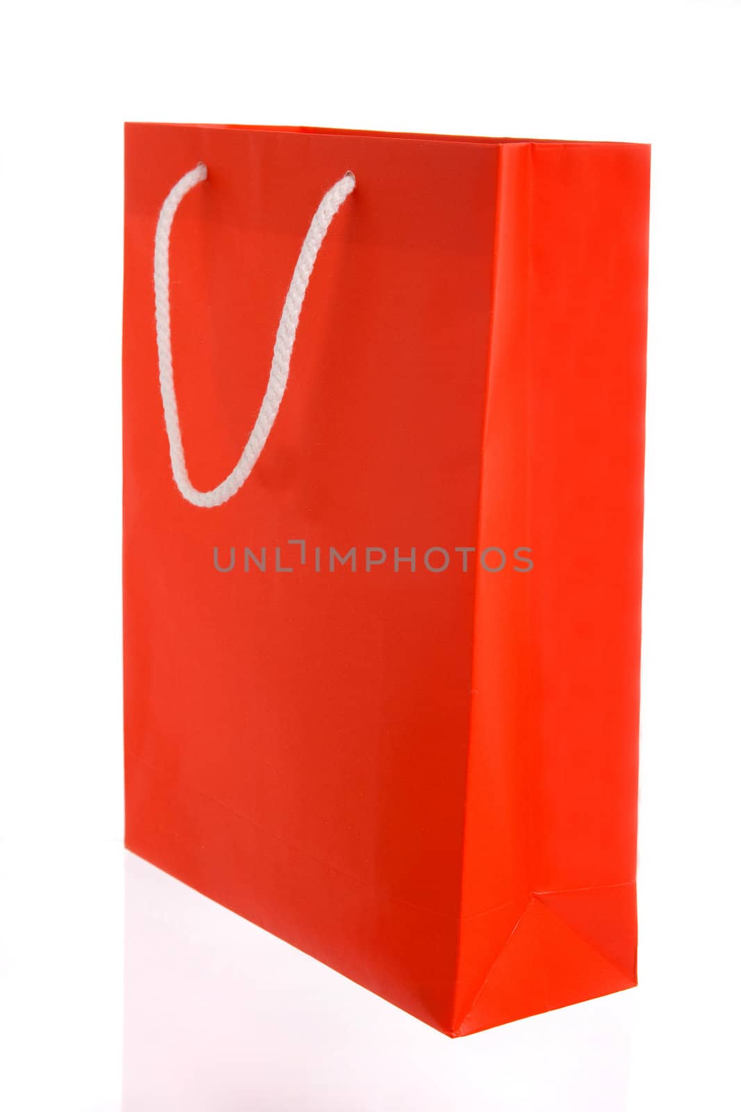 Red paper bag with white handles isolated on white