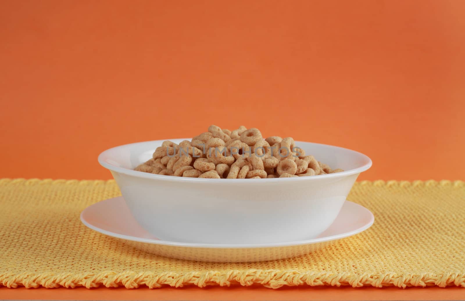 oat, ring, cereals in white bowl, yellow tablecloth, orange background