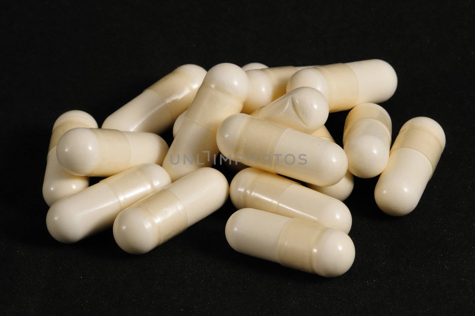 White capsules on a black background