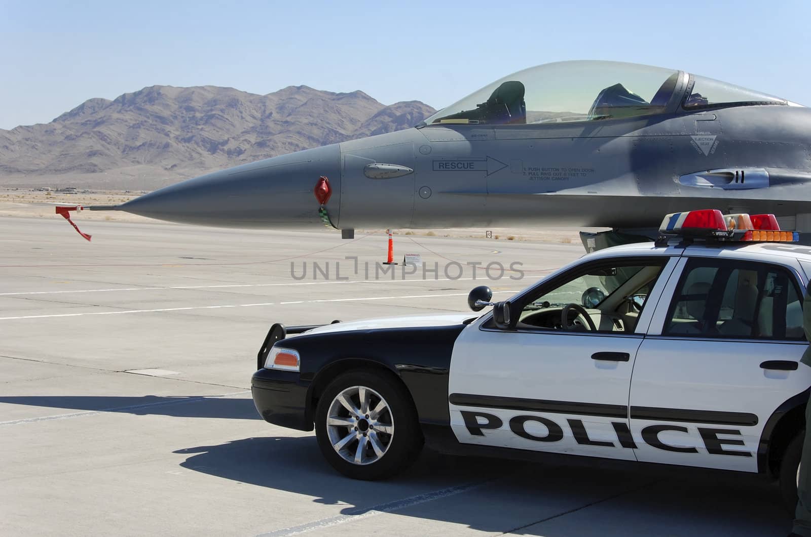 Air Force F-16 fighter aircraft ground display with police car