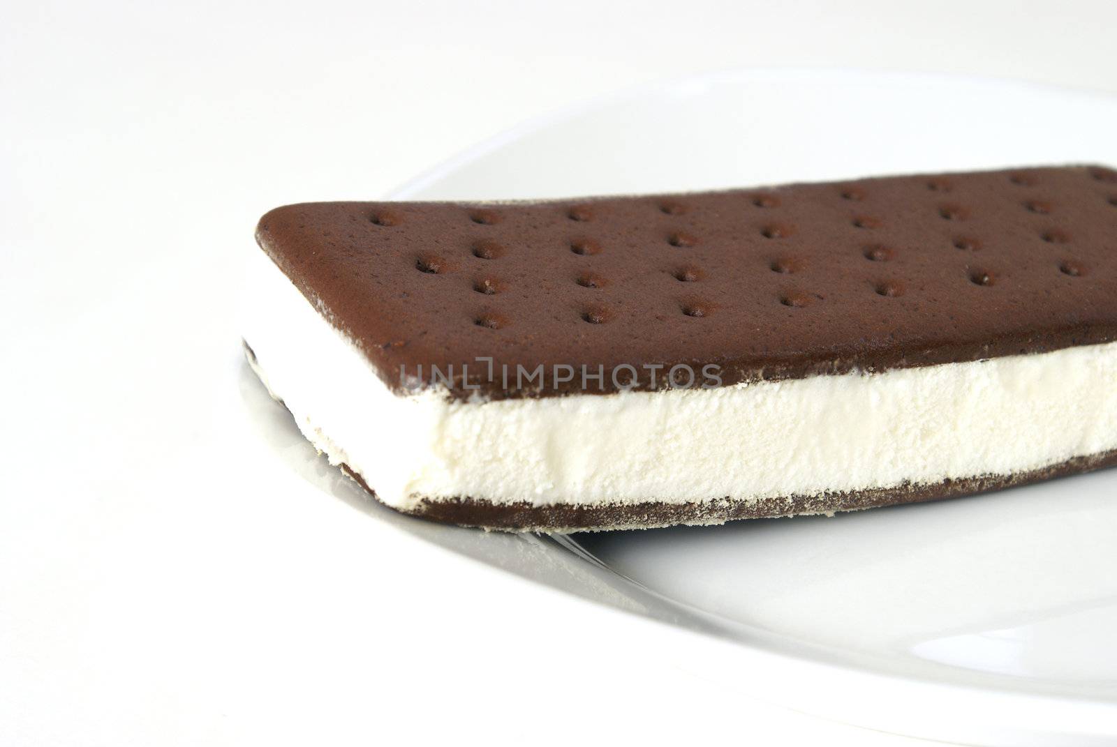 An ice-cream sandwich on a white plate.