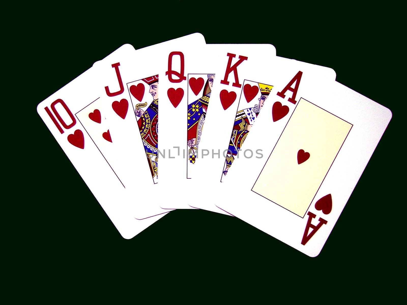 Royal Flush on a wooden table winning hand