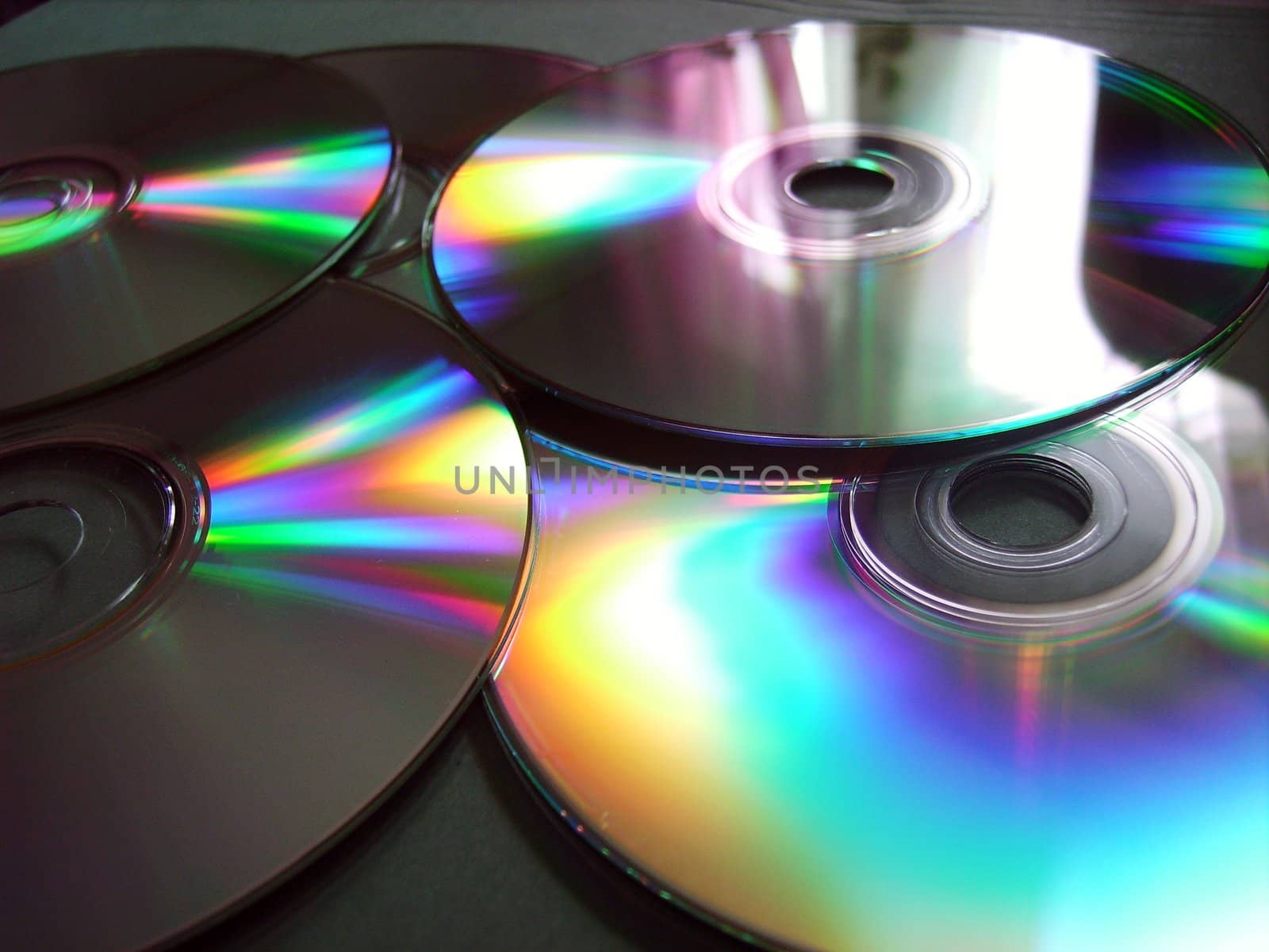 close-up of compact disks with reflections of color