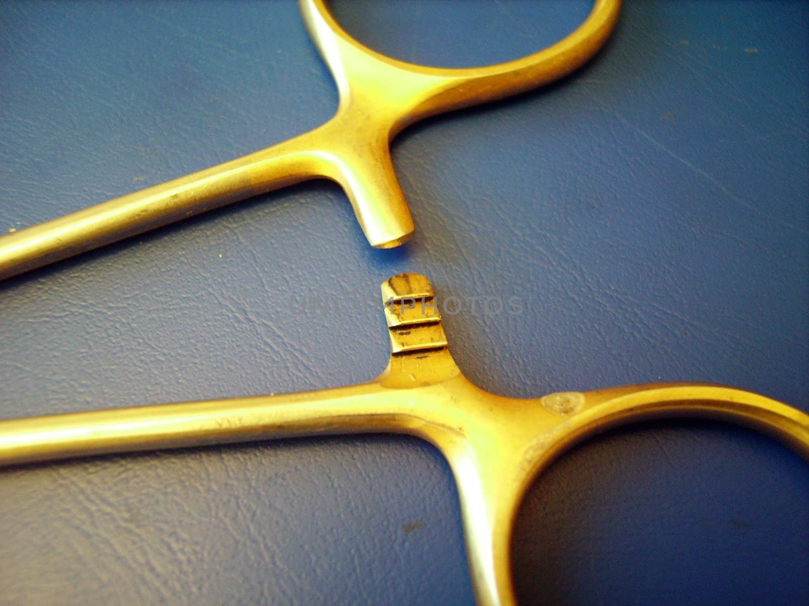 a close detail of a caliper hook on blue background