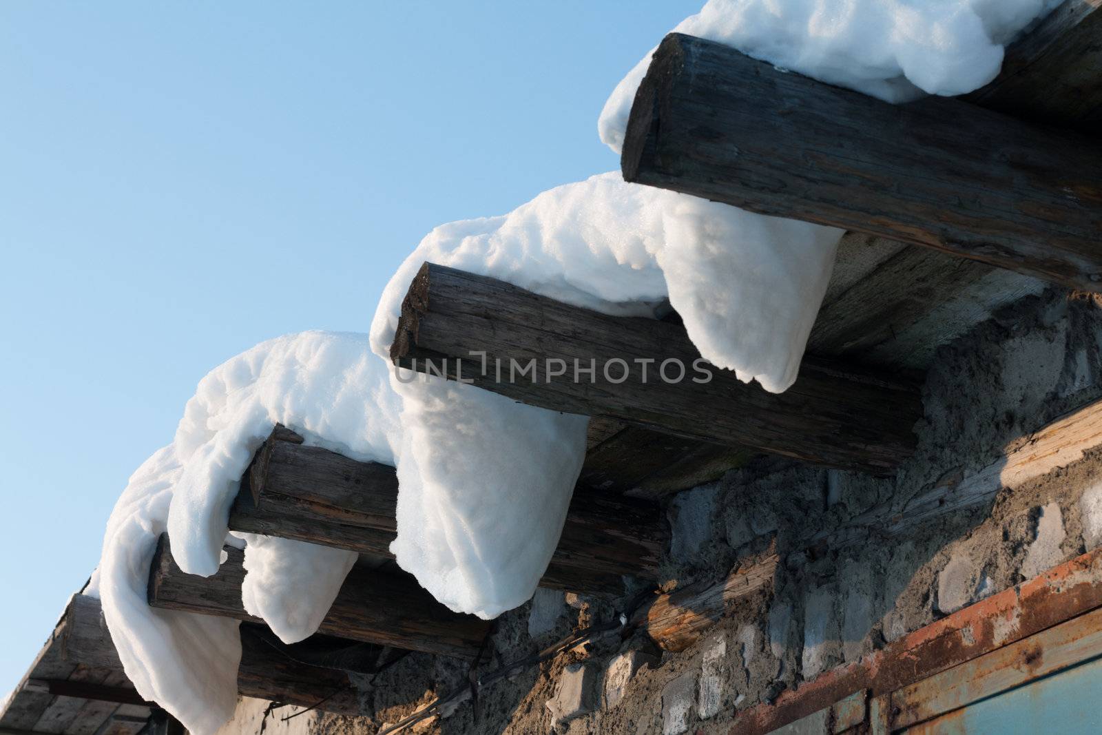 Wooden roof, drooping snow, winter, sunny, blue sky