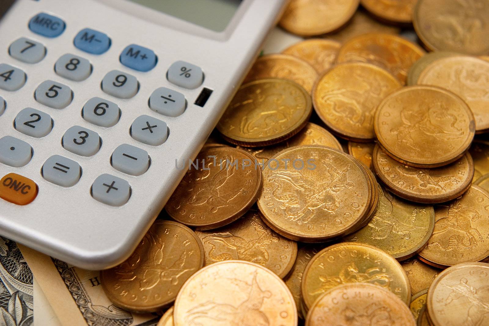 Calculator and coins. The concept of money, finance and savings