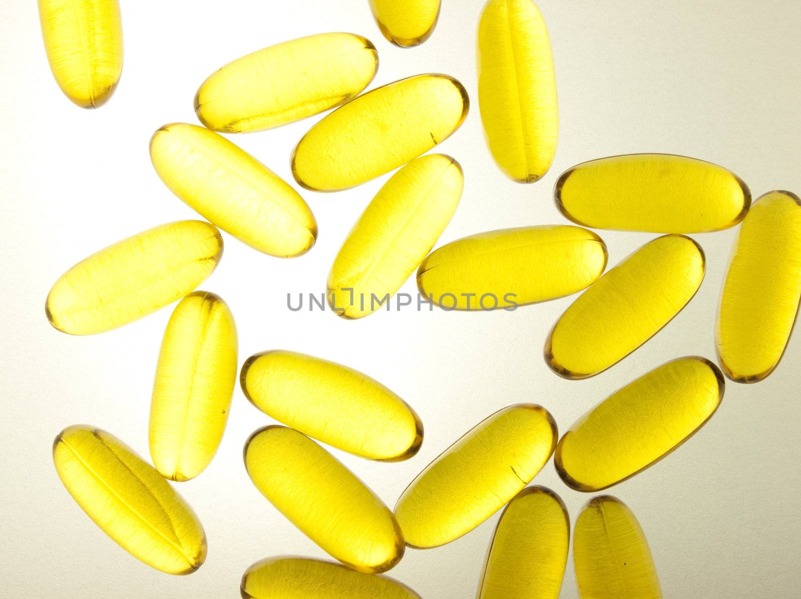 Oil vitamin yellow pills over the light