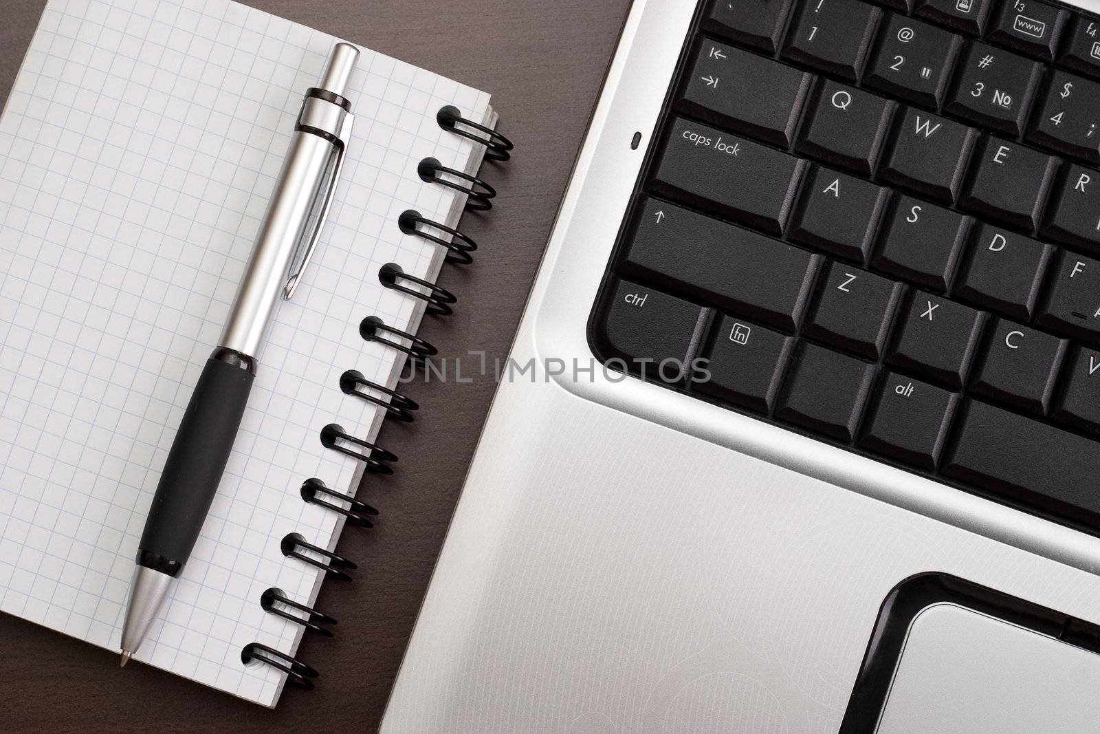 Working in the office: computer, papers and pen
