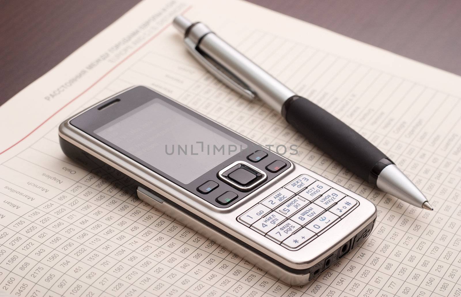 Business still-life: phone, papers and pen