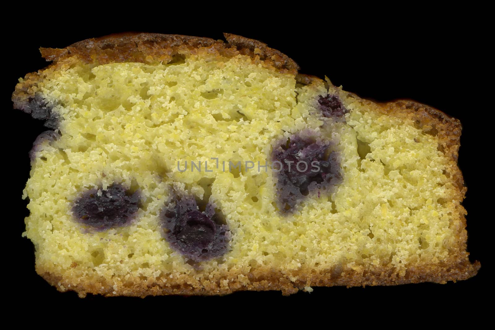 slice of homemade cornbread with blueberries isolated on black