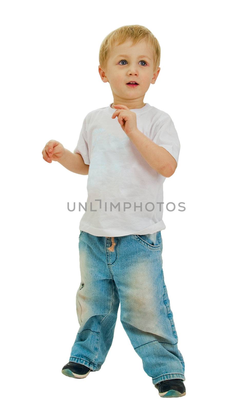 Boy of three years, dressed in a white shirt and blue jeans poses