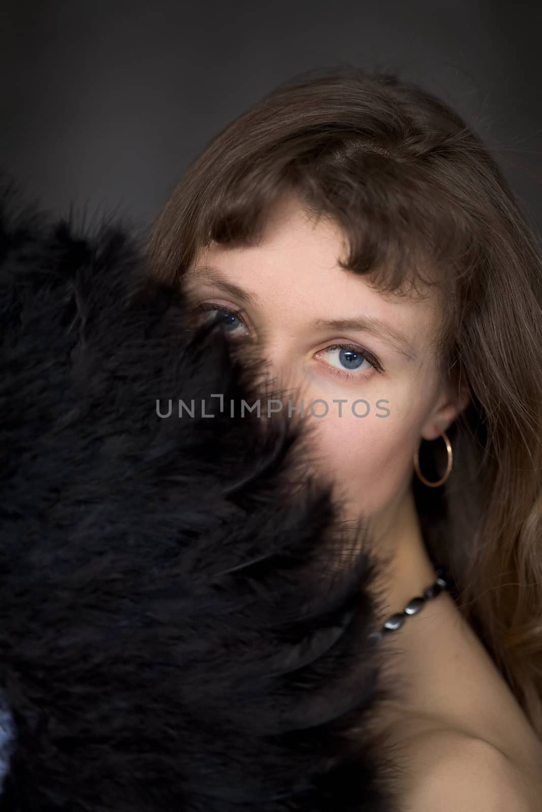 Portrait of the girl with a fan in hand