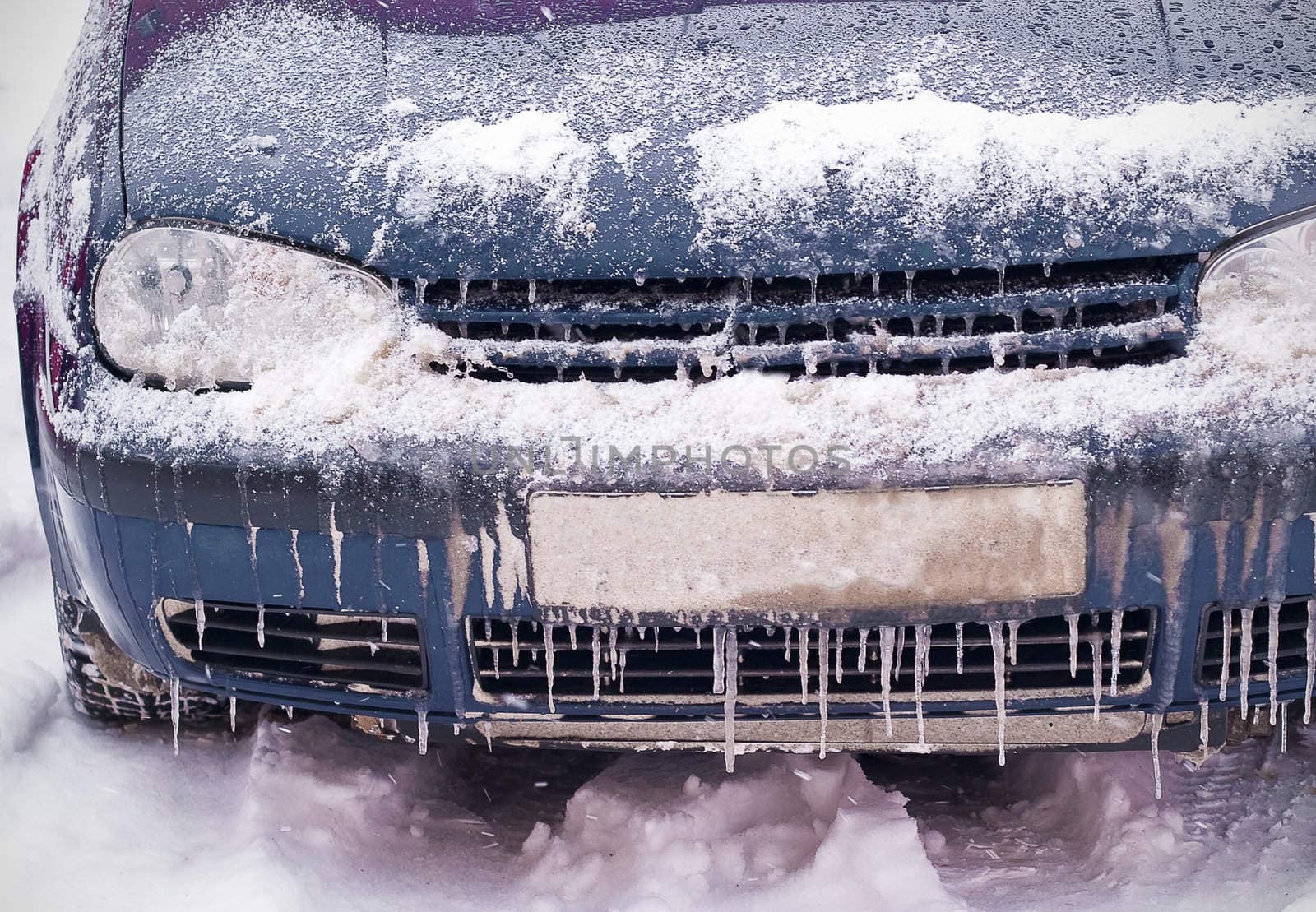 Frozen car covered with snow and ice