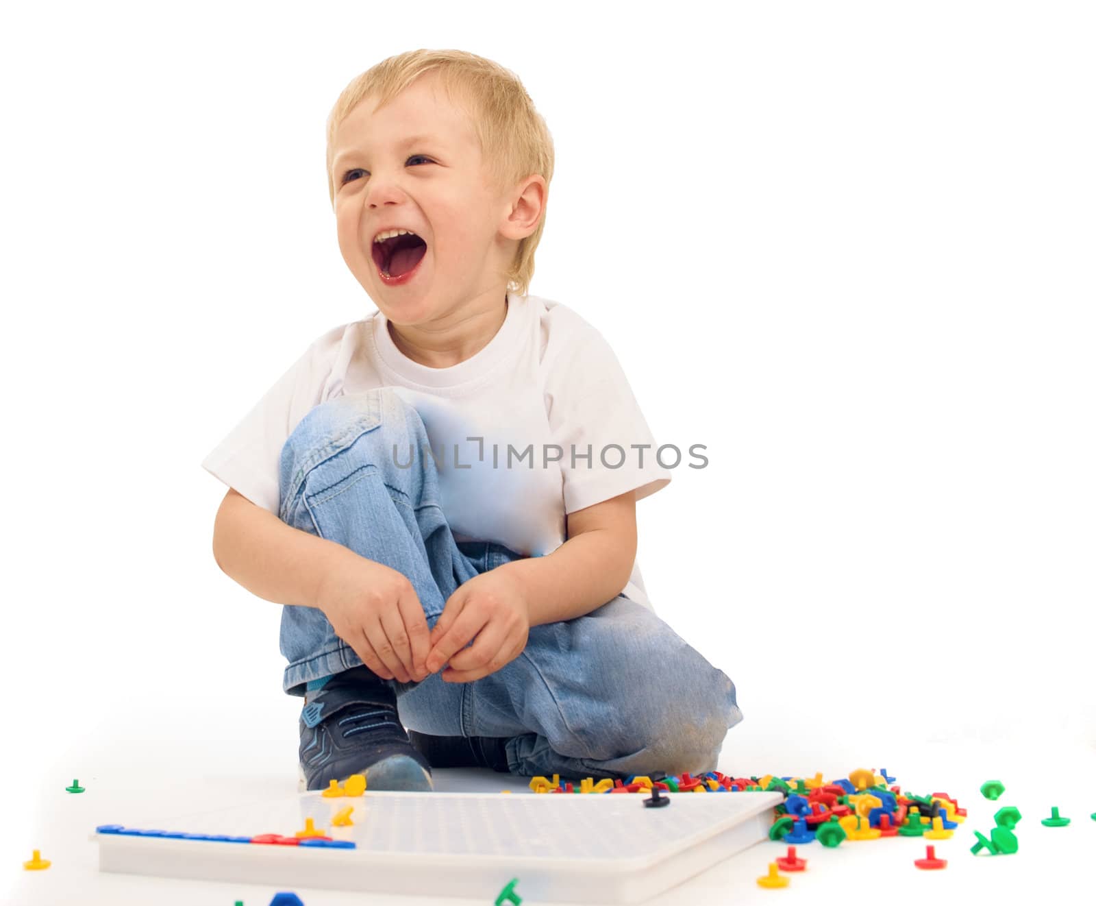 Boy of three years playing and laughing isolated on white background
