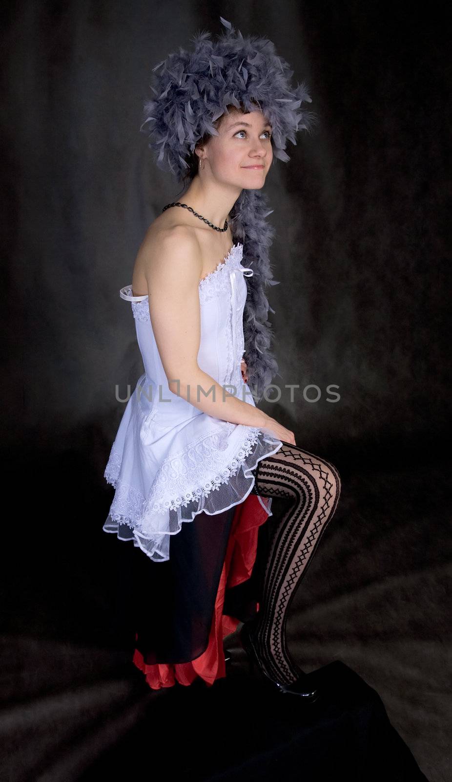 Portrait of the sexy beautiful girl with a boa on a head