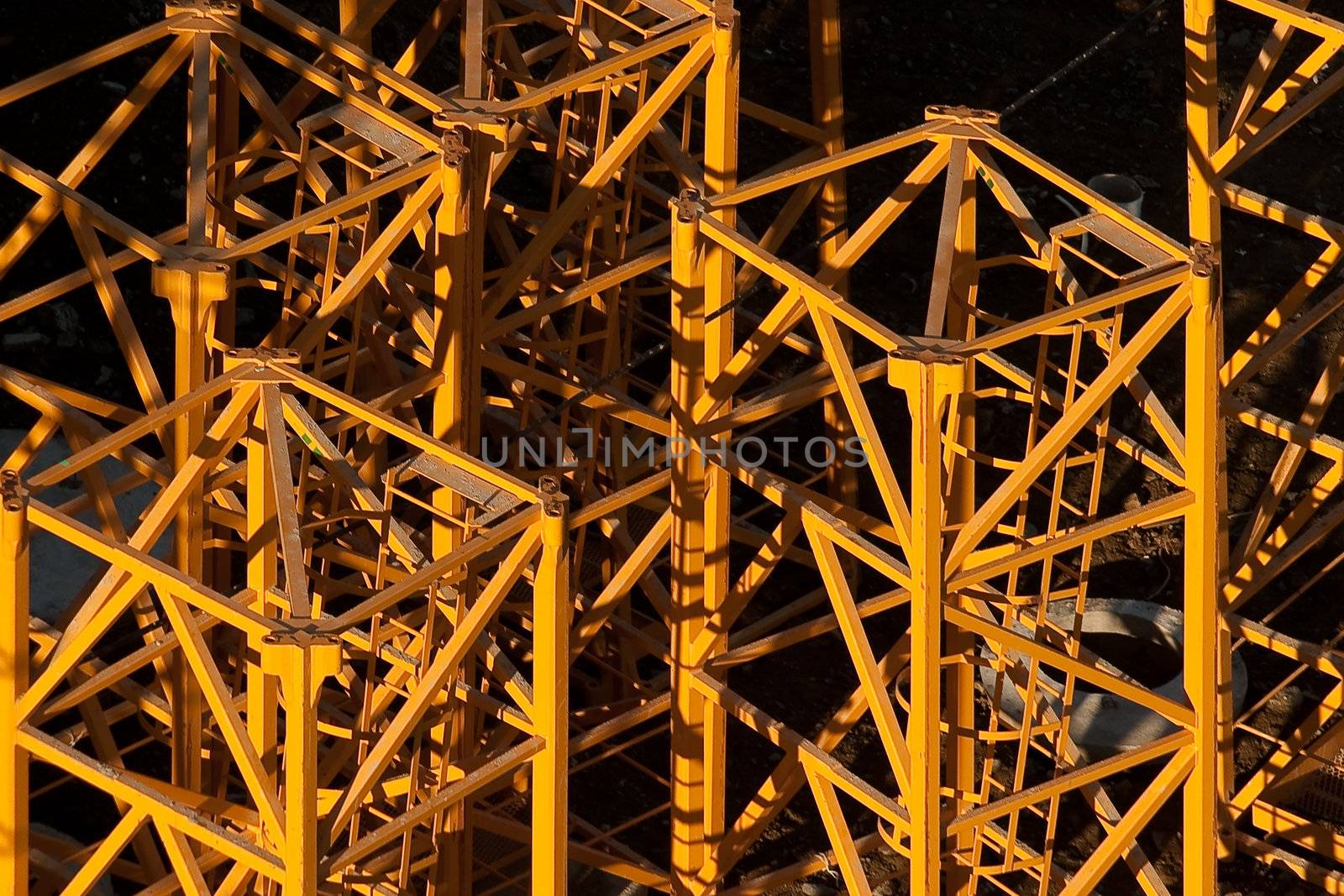 Industrial background. Part of high-rise construction crane lit bright sun