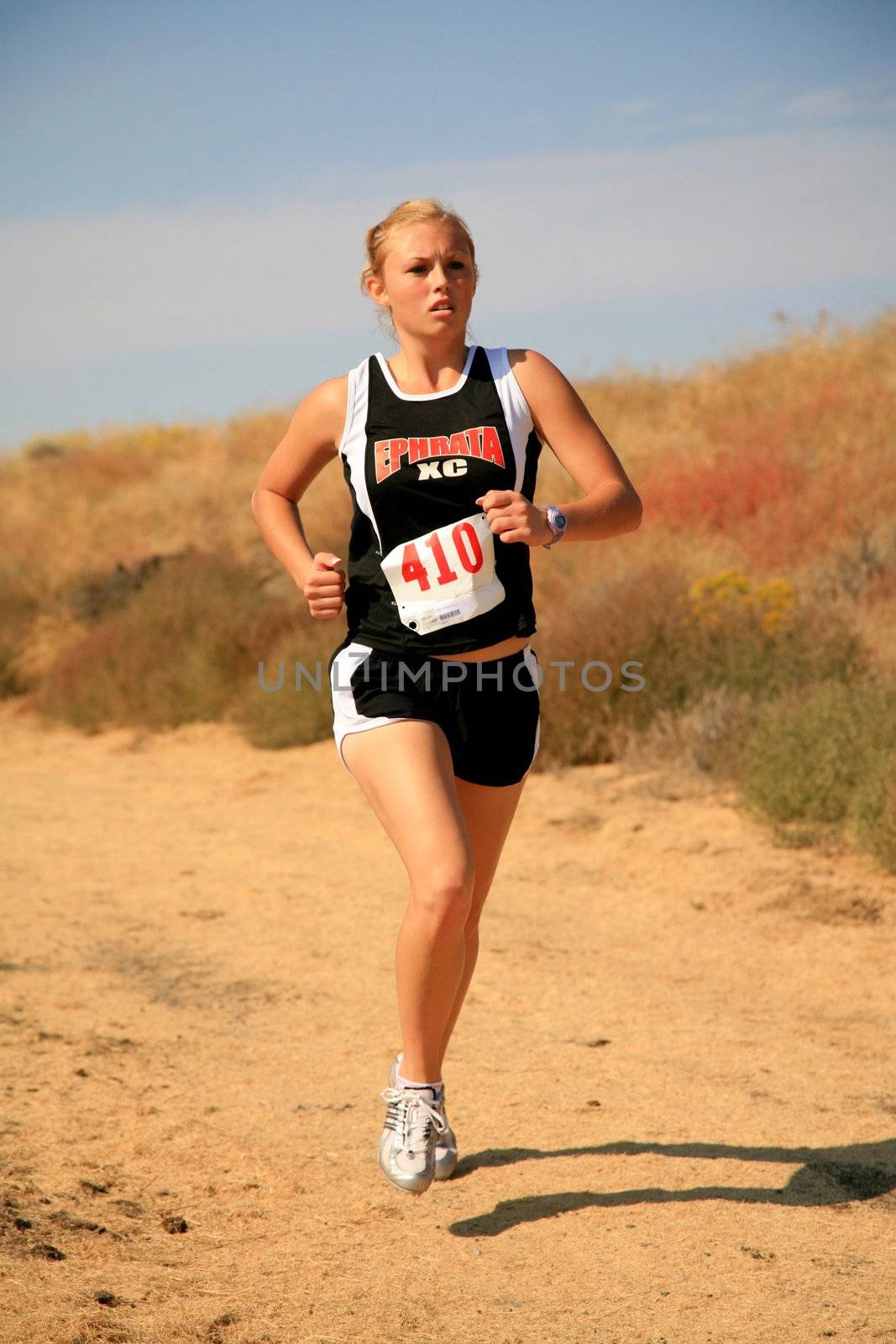 A woman competing in a cross country race
