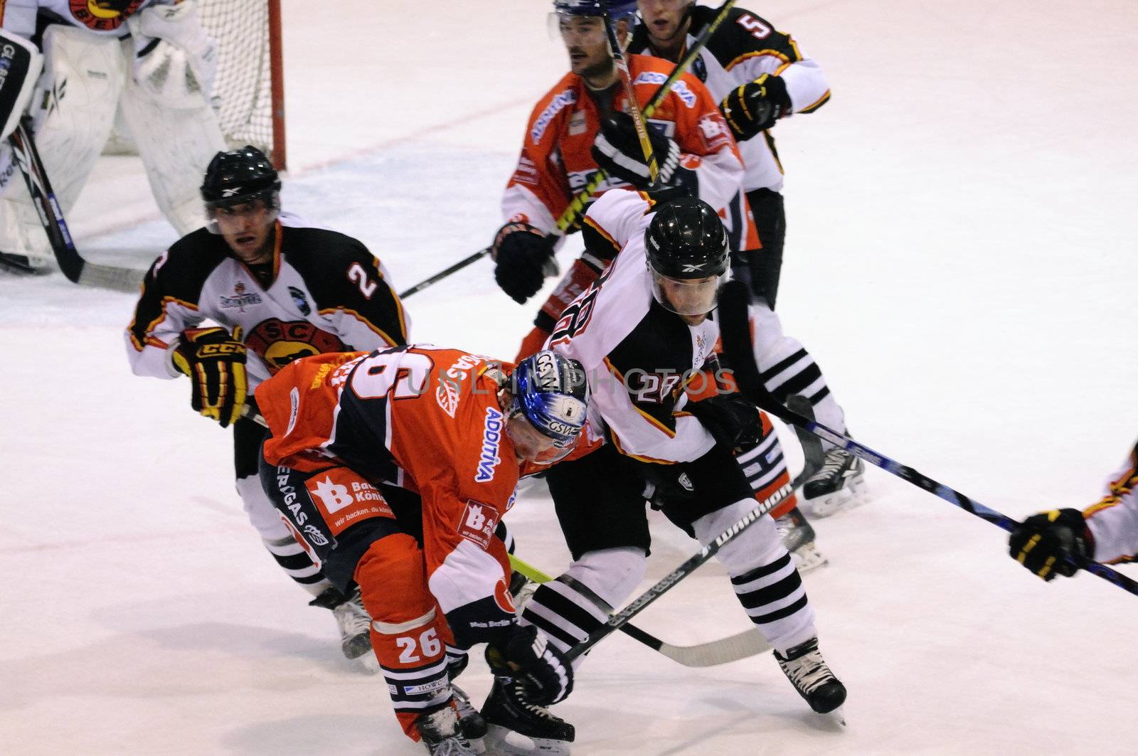 ZELL AM SEE; AUSTRIA - SEPTEMBER 4: Red Bull Salute Tournament Semifinal. Hard hit to the head from Pluess (Bern) vs. Busch (Berlin).  Game between SC Bern and Eisbaeren Berlin (Result 1-5) on September 4, 2010.