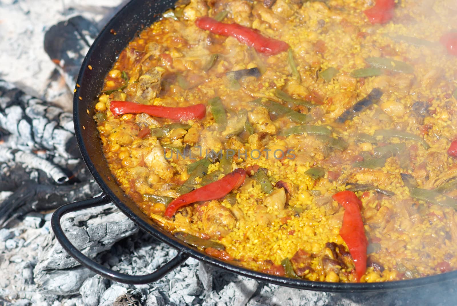 Traditional paella cooking by hemeroskopion